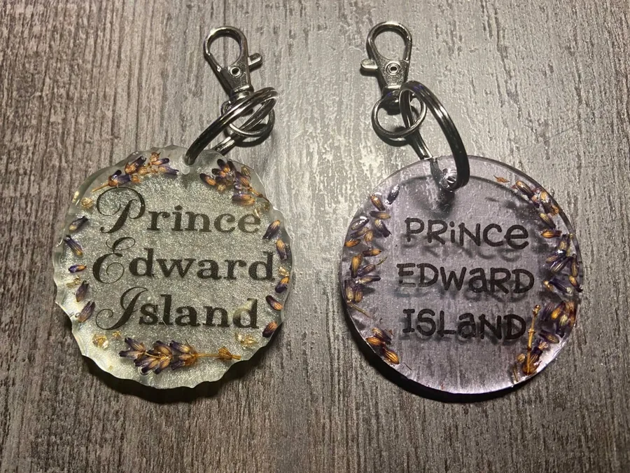 Two round resin keychains with dried lavender and Prince Edward Island lettering