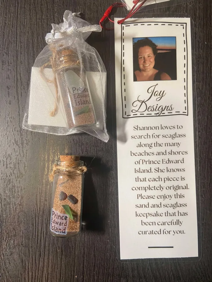Sea glass and sand in a small corked bottle with the Joy Designs maker card